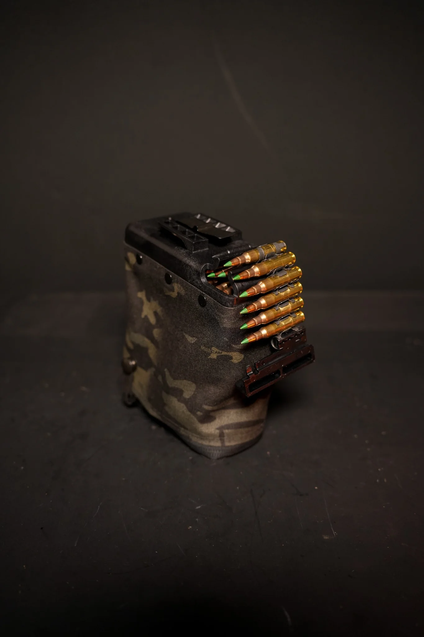 Black Multicam 200 round nutsack loaded with linked M855 5.56